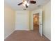 Bright bedroom with ceiling fan, closet and carpeted floor at 11903 Greengate Dr, Hudson, FL 34669