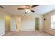 This carpeted bedroom has a fan and access to closet and bathroom at 11903 Greengate Dr, Hudson, FL 34669