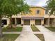 Inviting townhome featuring a two-car garage, neutral paint scheme, and manicured landscaping at 11903 Greengate Dr, Hudson, FL 34669