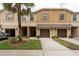 Inviting townhome exterior with well-kept landscaping, driveways, and attached garages at 11903 Greengate Dr, Hudson, FL 34669