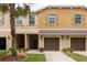 Inviting townhome featuring a well-maintained facade, attached garage, and front lawn landscaping at 11903 Greengate Dr, Hudson, FL 34669