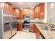 Well-equipped kitchen featuring granite countertops and stainless steel appliances at 11903 Greengate Dr, Hudson, FL 34669