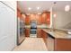 Updated kitchen boasts stainless appliances, granite countertops, and wood cabinetry at 11903 Greengate Dr, Hudson, FL 34669