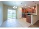 Eat-in kitchen featuring stainless steel appliances, wood cabinets, and tile floors at 11903 Greengate Dr, Hudson, FL 34669