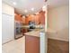 Modern kitchen with stainless steel appliances, tile floors, and granite counters at 11903 Greengate Dr, Hudson, FL 34669