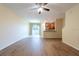 Spacious living room features hard wood floors, neutral walls, and a sliding glass door at 11903 Greengate Dr, Hudson, FL 34669