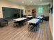 Bright meeting room with tables, chairs, and a comfortable seating area for gatherings and activities at 11903 Greengate Dr, Hudson, FL 34669