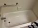 Clean white bathtub with chrome fixtures, grab bar, and soap dish, offering safety and convenience at 1200 37Th N St # 403, St Petersburg, FL 33713