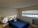 Cozy bedroom featuring window, and blue quilt on the bed with patterned headboard at 1200 37Th N St # 403, St Petersburg, FL 33713