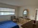 Bedroom featuring patterned chair, dresser with mirror and window with a view at 1200 37Th N St # 403, St Petersburg, FL 33713