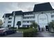 Library Lake Condominiums featuring white facade, black roofs, well-maintained landscaping and ample parking at 1200 37Th N St # 403, St Petersburg, FL 33713