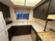 A vintage kitchen featuring wood cabinets, formica countertops, double sink and a window at 1200 37Th N St # 403, St Petersburg, FL 33713