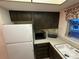 Kitchen featuring dark cabinets, white countertops, and stainless steel appliances, providing a practical space at 1200 37Th N St # 403, St Petersburg, FL 33713