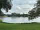 Scenic lake view with a modern building in the background and lush greenery at 1200 37Th N St # 403, St Petersburg, FL 33713