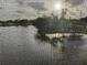 Lake view through a screened window, showcasing the beauty of the waterfront scenery at 1200 37Th N St # 403, St Petersburg, FL 33713