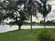 Beautiful lake view with palm trees, manicured lawn and fountain in the background at 1200 37Th N St # 403, St Petersburg, FL 33713
