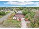 Aerial view showcasing a well-maintained home with a fenced yard, long driveway, and serene surroundings at 12279 Elmore Dr, Spring Hill, FL 34609