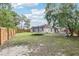 Large, fenced backyard with trampoline and screened pool enclosure, ideal for Gathering entertainment at 12279 Elmore Dr, Spring Hill, FL 34609