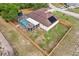 Aerial view of a backyard featuring a screened-in pool, grassy area, and a wood fence at 12279 Elmore Dr, Spring Hill, FL 34609