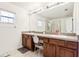 Well-lit bathroom featuring a double vanity, large mirror, and a glass-enclosed shower at 12279 Elmore Dr, Spring Hill, FL 34609