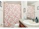 Bathroom with patterned shower curtain, clean single vanity, and well-lit mirror at 12279 Elmore Dr, Spring Hill, FL 34609