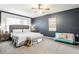 This bedroom features a dark blue wall, carpet and ceiling fan at 12279 Elmore Dr, Spring Hill, FL 34609