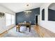 Elegant dining room with modern lighting, a large wooden table, and a stylish accent wall at 12279 Elmore Dr, Spring Hill, FL 34609