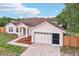 Attractive single-Gathering home with a brown roof, well-kept lawn, and attached garage at 12279 Elmore Dr, Spring Hill, FL 34609