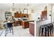 Bright kitchen with stainless steel appliances, a breakfast bar, and tile flooring at 12279 Elmore Dr, Spring Hill, FL 34609