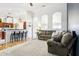 Bright, open-concept living room and kitchen featuring archways, bar seating and comfortable furnishings at 12279 Elmore Dr, Spring Hill, FL 34609