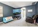 This cozy living room offers a comfortable layout, carpet and TV mounted on the wall at 12279 Elmore Dr, Spring Hill, FL 34609