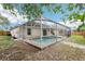 Screened-in backyard pool with brick deck and covered enclosure offers relaxation and leisure at 12279 Elmore Dr, Spring Hill, FL 34609