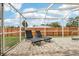 Relaxing screened-in pool area with brick pavers and outdoor lounge chairs at 12279 Elmore Dr, Spring Hill, FL 34609