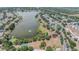 Scenic aerial view of a well-planned community alongside a serene lake, featuring a park with a playground at 12813 Kings Lake Dr, Gibsonton, FL 33534