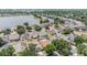 Aerial view of a lakeside residential area featuring well-maintained homes with lush greenery and backyard pools at 12813 Kings Lake Dr, Gibsonton, FL 33534