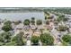 Aerial view of a neighborhood featuring backyard pools and manicured lawns near a serene lake at 12813 Kings Lake Dr, Gibsonton, FL 33534