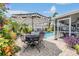 Paver patio and pristine pool with patio furniture and tropical landscaping at 12813 Kings Lake Dr, Gibsonton, FL 33534