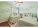 This bedroom offers two beds, a bicycle decor and is decorated in a light green at 12813 Kings Lake Dr, Gibsonton, FL 33534