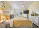This bedroom has a bright, yellow aesthetic, including matching bedding at 12813 Kings Lake Dr, Gibsonton, FL 33534