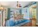 The dining room features hardwood floors, blue accents, and a ceiling fan at 12813 Kings Lake Dr, Gibsonton, FL 33534