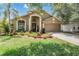 Inviting home exterior with lush green lawn and landscaped flower beds creating a welcoming curb appeal at 12813 Kings Lake Dr, Gibsonton, FL 33534