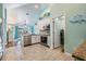 Bright kitchen features stainless steel appliances, white cabinetry and tiled floors at 12813 Kings Lake Dr, Gibsonton, FL 33534