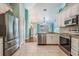 A modern kitchen features stainless steel appliances, white cabinets, and an open floor plan at 12813 Kings Lake Dr, Gibsonton, FL 33534