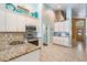 Bright kitchen with granite breakfast bar, stainless steel appliances, and beach-themed décor at 12813 Kings Lake Dr, Gibsonton, FL 33534