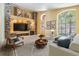 Cozy living room featuring a stone accent wall, modern furniture, and ample natural light at 12813 Kings Lake Dr, Gibsonton, FL 33534