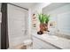 Clean bathroom featuring a tub, shower, and granite countertop with modern fixtures and decor at 13570 Tropical Breeze Way, Hudson, FL 34669