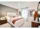 Inviting bedroom with a comfortable bed, side tables, and artistic decor for a relaxing ambiance at 13570 Tropical Breeze Way, Hudson, FL 34669