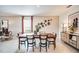 Elegantly decorated dining room featuring a large table, stylish decor, and plenty of natural light at 13570 Tropical Breeze Way, Hudson, FL 34669