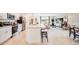 Open-concept kitchen flows into the living area, featuring granite counters, stainless appliances, and tile floors at 13570 Tropical Breeze Way, Hudson, FL 34669