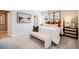 Cozy main bedroom with carpet flooring, decorative wall art, and a comfortable upholstered bench at 13570 Tropical Breeze Way, Hudson, FL 34669